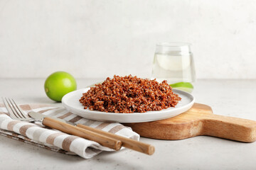 Composition with tasty quinoa and lime on light background