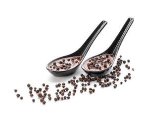 Spoons with peppercorn sauce on white background