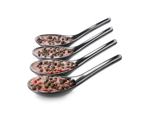 Spoons with peppercorn sauce on white background