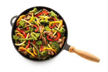 Frying pan with tasty beef and vegetables on white background