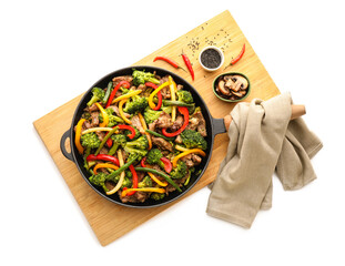 Frying pan with tasty beef and vegetables on white background