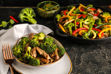 Tasty beef and vegetables on dark background