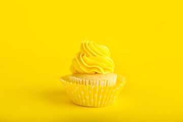 Tasty cupcake on color background