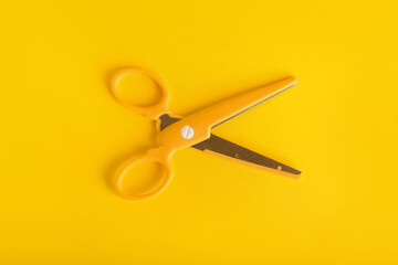 Stylish scissors on color background