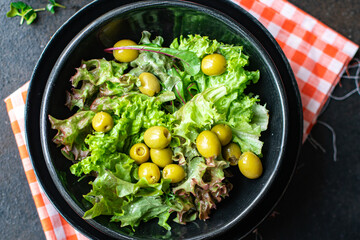 olive salad green leaves lettuce mix fresh healthy appetizer diet meal vegan or vegetarian foodsnack copy space food background rustic top view 