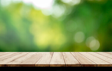 blurred background of green park in summer, Wood table top on shiny bokeh green background. For...