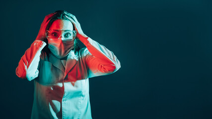 Laboratory mistake. Medical error. Experiment failure. Anxious scared female scientist in face mask goggles clutching head with omg reaction isolated on teal blue copy space banner.