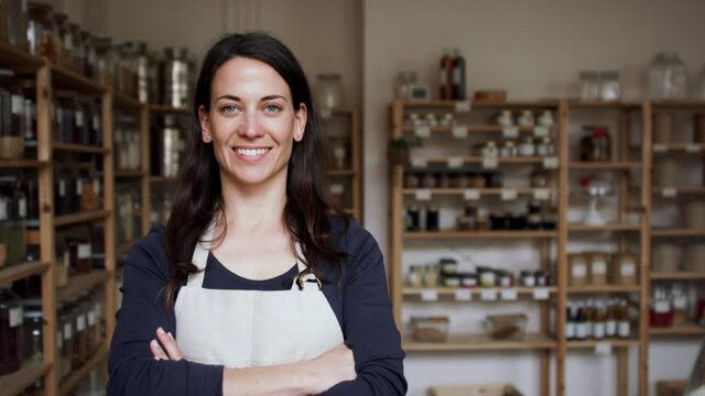 Female owner of zero waste shop, looking at camera.