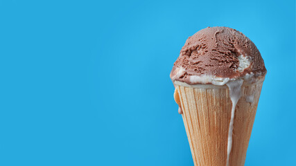 Ball of chocolate ice cream in waffle cone with free space for text