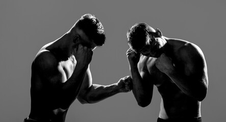 Two young boxers facing each other in a match. Two men boxers boxing on isolated silhouette...