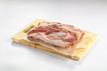 Raw pork fillet over board