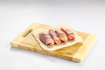 Raw chicken leg fillet over board