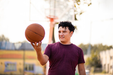 Man on basketball court holding ball.