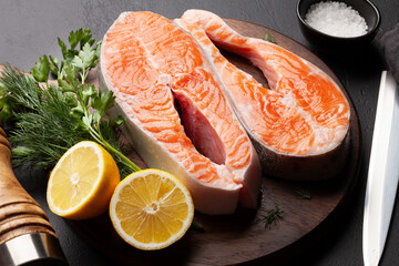 Fresh raw salmon cooking. Fish steaks with herbs and spices