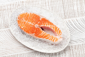 Fresh raw salmon cooking. Fish steak on ice