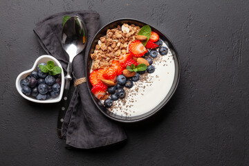Healthy breakfast with bowl of granola, yogurt and fresh berries