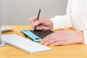 Fototapeta premium A graphic designer works on a digital tablet. work from home