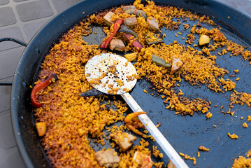 spanish paella rice pan served. selective focus