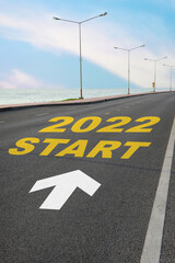 Start to 2022 written on the road on beach background with blue sky. Business planning concept and new year beginning success idea