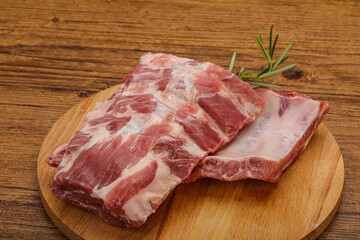 Raw pork ribs served rosemary