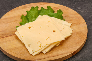 Sliced yellow cheese over board