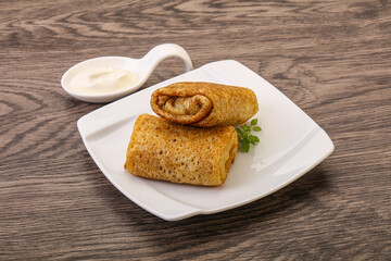 Staffed pancakes served sour cream