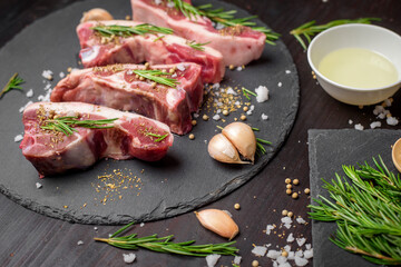 Fresh raw  beef and ingredients steak on black stone board over black wooden table