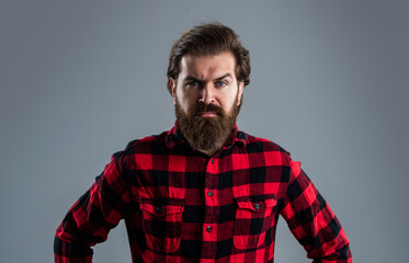 Obraz premium brutal bearded man in checkered shirt. mature guy with beard and moustache
