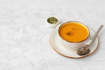 Obraz na płótnie Canvas Blended pumpkin soup in bowl on gray background
