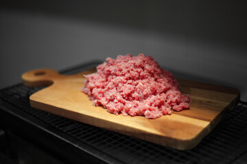 Minced meat on cutting board in kitchen