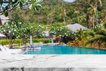 Empty white marble stone table top and blurred swimming pool in tropical resort in summer banner...