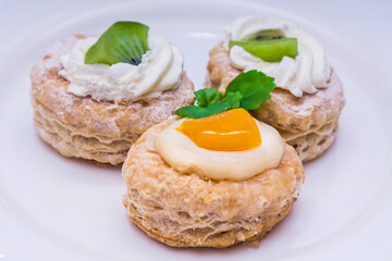tasty mini puff pastry cakes with fruits