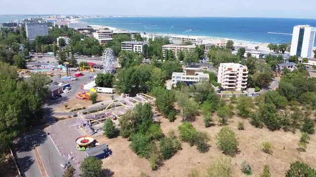 Aerial drone footage on the Black Sea coast ,flying over the riviera of Mamaia resort area and Mamaia lake  in Constanta City , Romania, a top travel destination , summer season