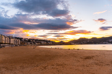 Orange sunset on the beautiful beach of La Concha in the city of San Sebastian, in the province of Gipuzkoa in the Basque Country