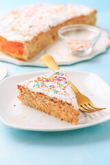 Homemade gluten-free almond case with lemon icing and sugar sprinkles