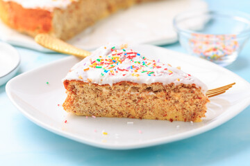 Homemade gluten-free almond case with lemon icing and sugar sprinkles