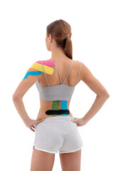Therapy with kinesio tex tape. Woman with kinesiology tape on back and shoulder. Isolated on white...