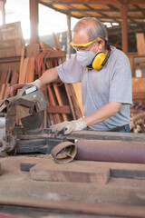 Senior Asian carpenter working with wood