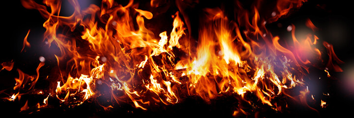Fototapeta premium Wide Fire flames on black background. fire burst texture for banner backdrop.