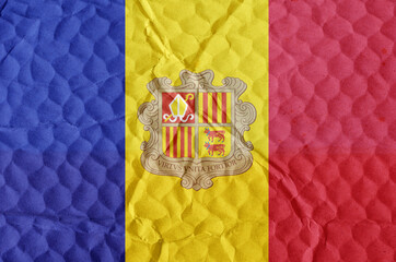 Red-yellow-blue Andoran National Flag on an uneven textured surface.