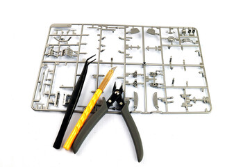 Plastic model making with tool , a plastic grid of parts for a scale model car that is delicate to assemble,