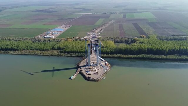 Suspended bridge under construction , over the Danube river near Galati and Braila Cities , connecting those cities with the Danube Delta natural reserve , aerial footage from the drone with the phase