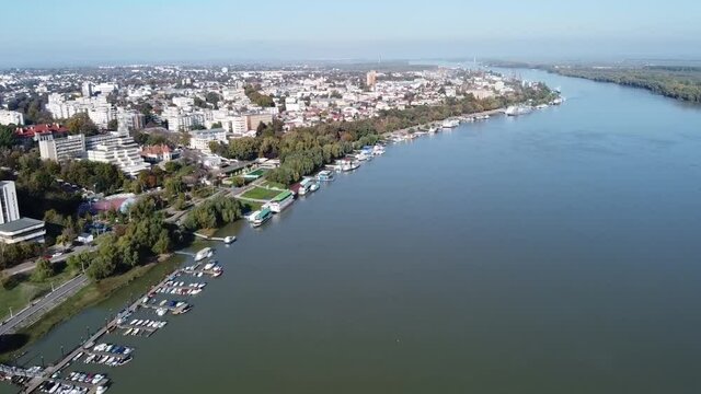 Braila City in eastern Romania , Danube river and walkway with the piers on the shore , aerial drone footage