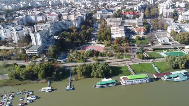 Braila City in eastern Romania , Danube river and walkway with the piers on the shore , aerial drone footage