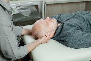 CST practitioner relieves compression in the bones of the head, sacrum, and spinal column using gentle hands-on CST technique