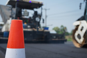 The image is blurred in the construction work. There is a red rubber cone on the front.