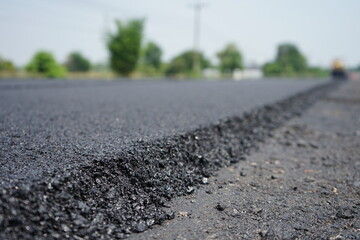 The image is blurred in the construction of asphalt road.