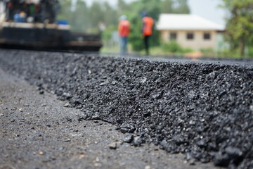 The image is blurred in the construction of asphalt road.