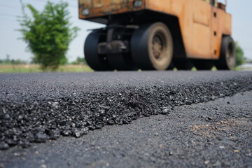 The image is blurred in the construction of asphalt road.