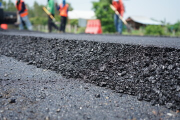 The image is blurred in the construction of asphalt road.